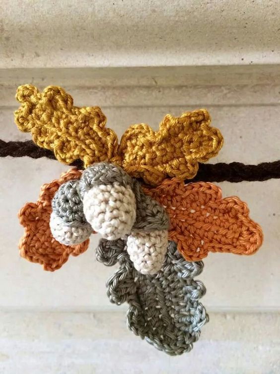 crocheted acorns on a leaf 4